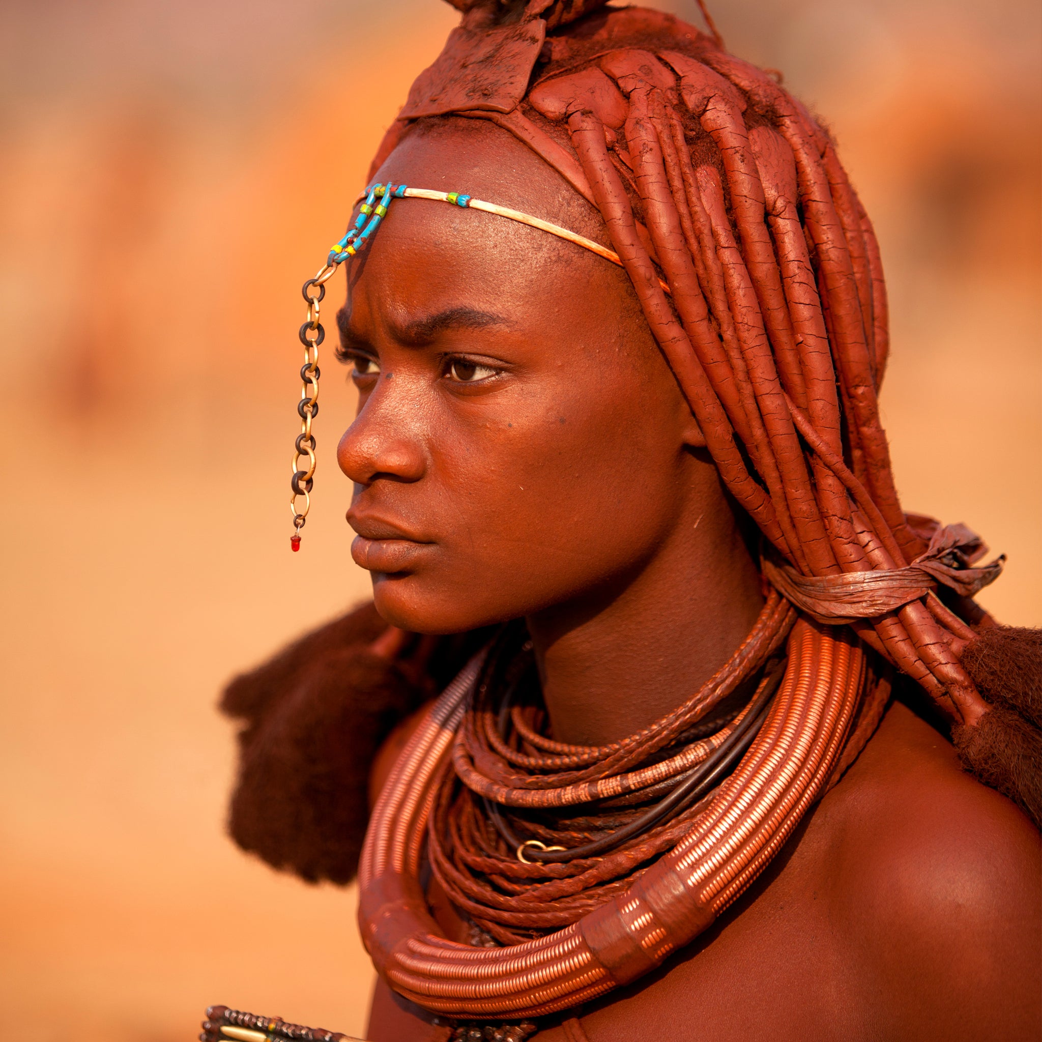 Smiling Himba girl with traditional jewelry